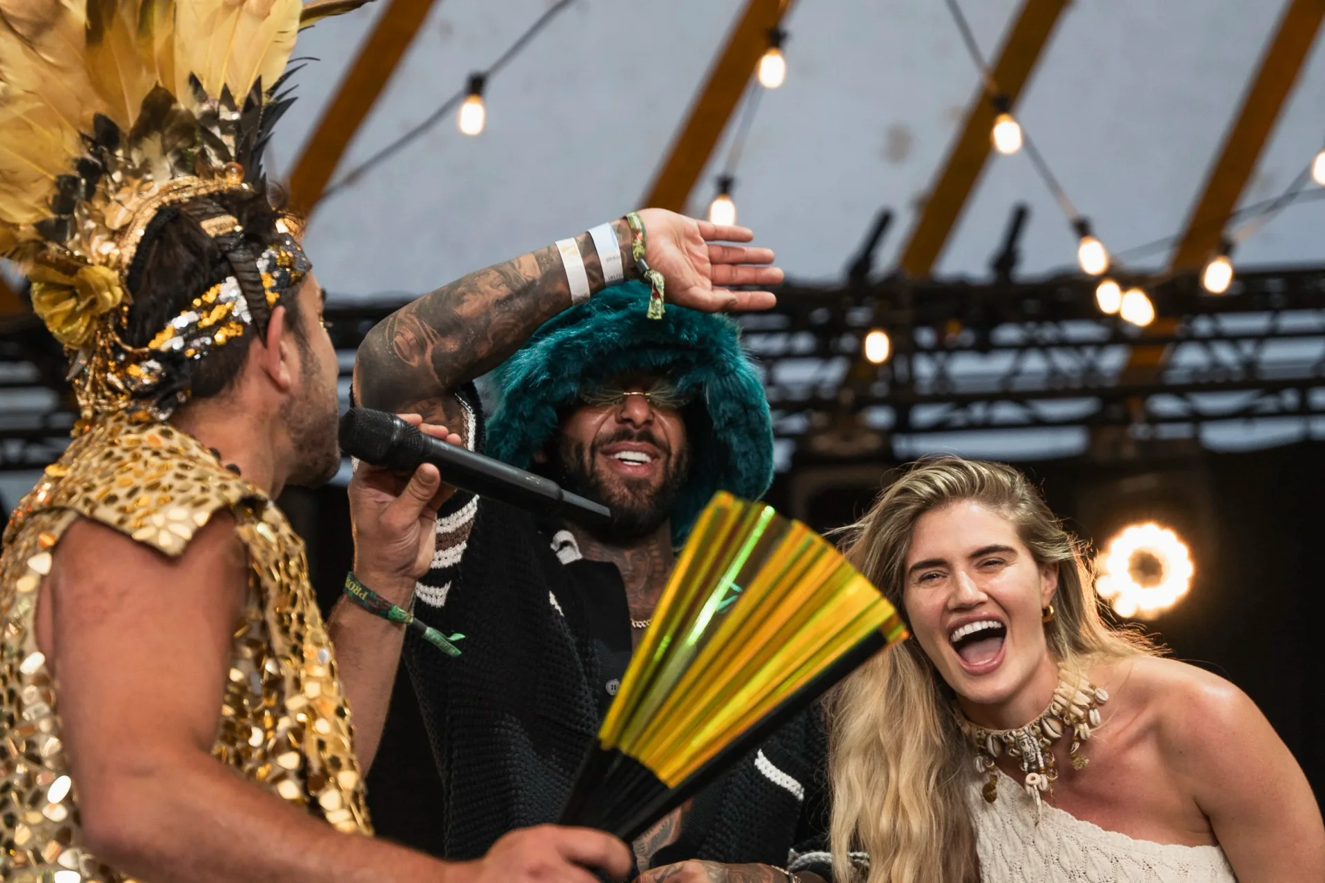 Brassique performers in gold costumes engaging a festival crowd