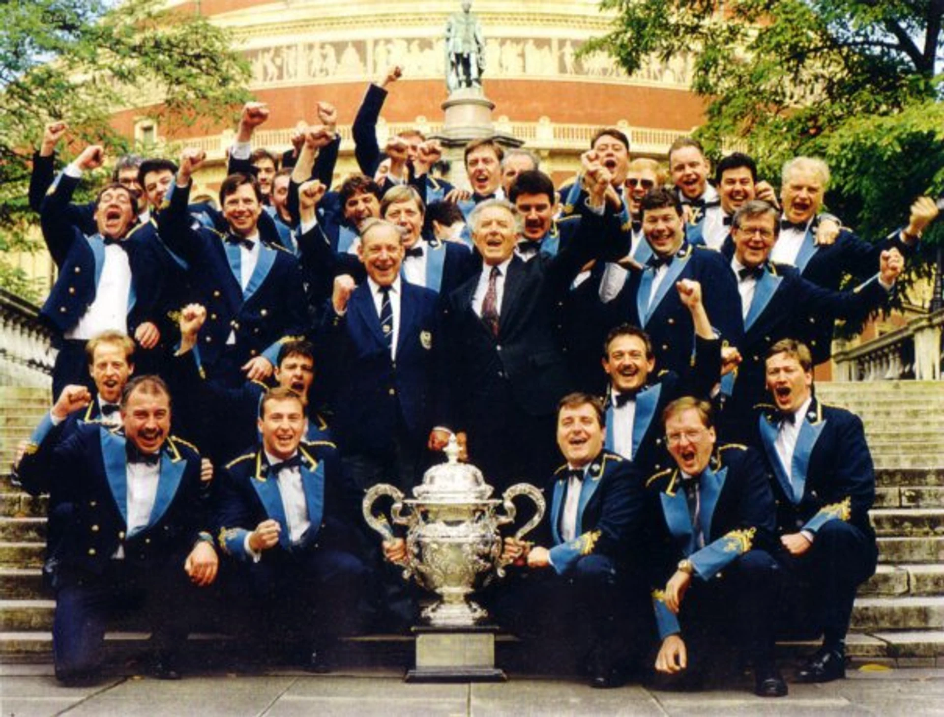 The KNDS Fairey Band celebrating on the steps of the Royal Albert Hall with the National Championship trophy in 1993